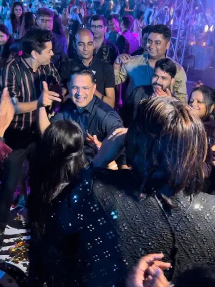 A candid shot of me sharing a laugh with a guest in the middle of the crowd. It's these personal, unscripted moments that make an event truly special.