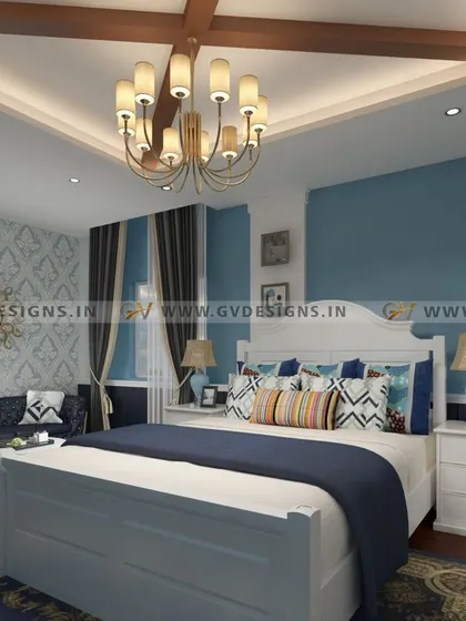 This vintage-inspired master bedroom uses a royal blue and white color scheme to create a classic look. The design features a retro sitting area, traditional wallpaper, and a false ceiling with a beautiful chandelier for a touch of old-world elegance.