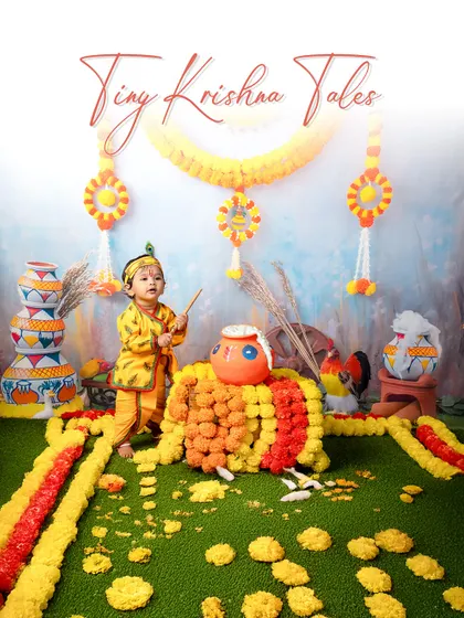 A playful little Kanha ready to break the dahi handi. The vibrant colors and traditional props in this setup create an authentic and joyful atmosphere.