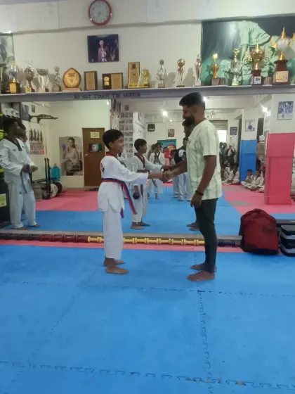 A student receives his red belt.