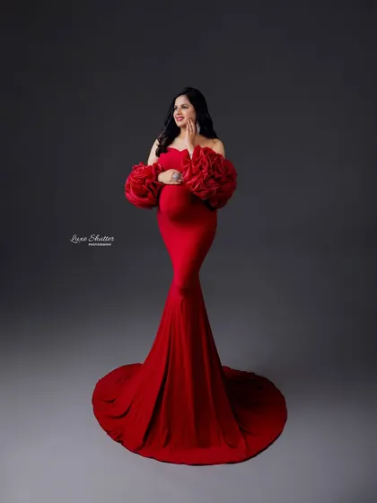 Motherhood and high fashion go hand in hand. This red gown with dramatic floral sleeves is a perfect example of a stylish and modern maternity portrait.