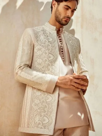 A sophisticated look for a groom or guest. This outfit features a beautifully embroidered Indo-Western jacket over a simple, well-fitted kurta.