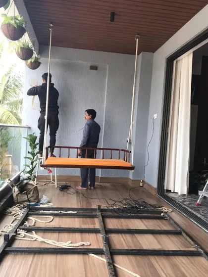 Our team at work installing a vertical garden frame on a balcony. This behind-the-scenes shot shows the metal grid structure being mounted before the planting modules and irrigation system are put in place.