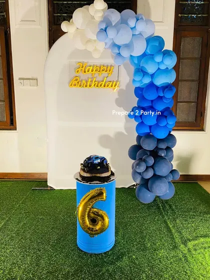 A close-up of the 6th birthday decor, showing the "Happy Birthday" sign and the gradient effect of the blue balloon arrangement.