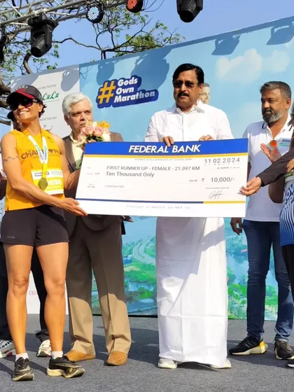 Receiving the prize check on stage at the Kochi Marathon. A great birthday gift to myself!