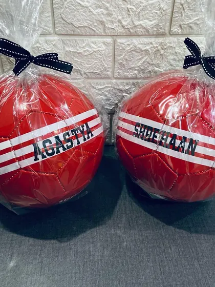 Two of our personalised footballs, wrapped and tied with a ribbon. They make a great impression as a party favor.