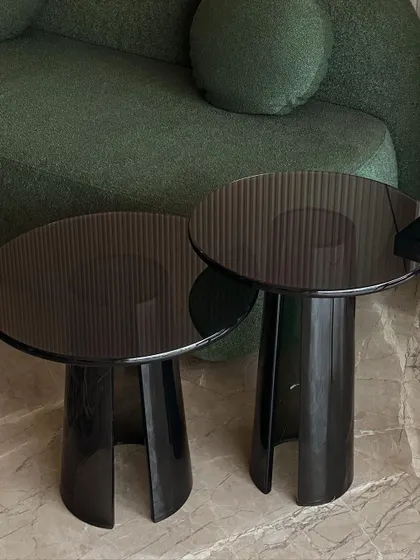 A pair of our custom hand-made acrylic side tables. Their smoky, translucent finish and clean, modern shape make them a versatile addition to any contemporary living room.
