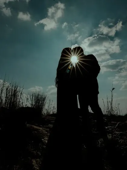 A dramatic pre-wedding silhouette against a brilliant sunburst. I use natural light to create powerful and artistic images that feel timeless.