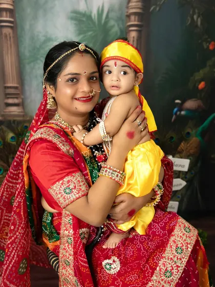 A mother and her baby, dressed as Yashoda and Krishna, share a beautiful moment during our Janmashtami special photoshoot.