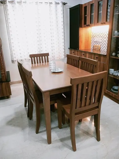 A side view of the dining set, showing how it integrates seamlessly with the custom crockery unit in the background, creating a unified and harmonious dining area.