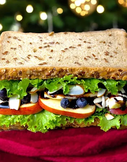 Celebrate the New Year in flavor with our exclusive party menu. This festive sandwich, with its Christmas-themed backdrop, is perfect for your holiday gatherings.