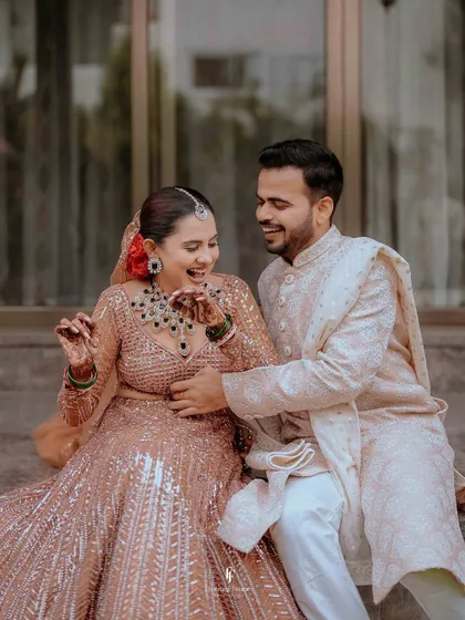 A candid shot of a Bengali bride sharing a laugh with her groom. I love capturing these unposed moments of joy that reflect the couple's true personalities.