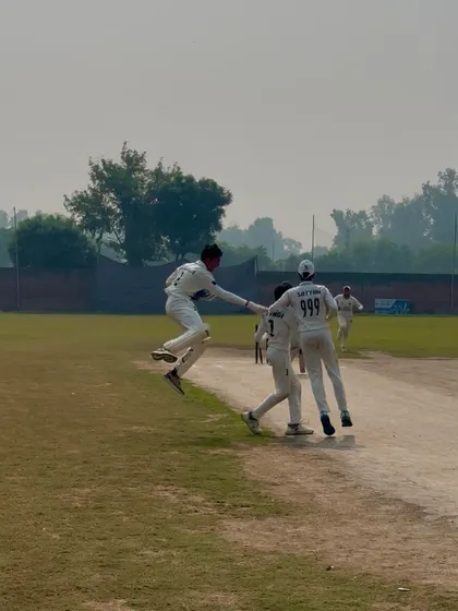An athletic celebration after taking a key wicket.