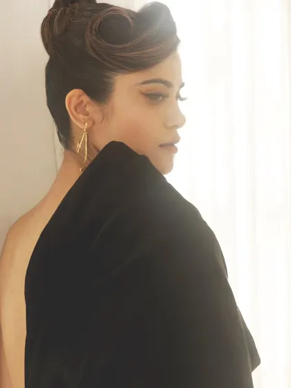 A classic profile shot showcasing the clean lines of this makeup look on Aaditi Pohankar. The winged liner and sculpted hair create a timeless sense of glamour.