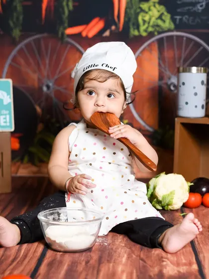 Tasting the ingredients is part of the fun in our 'Little Chef' photoshoot. I love capturing these playful, authentic moments.