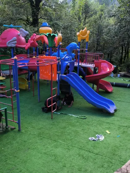 A wide shot of the completed children's park in Nainital. The entire area is now a bright, inviting, and safe space for families.