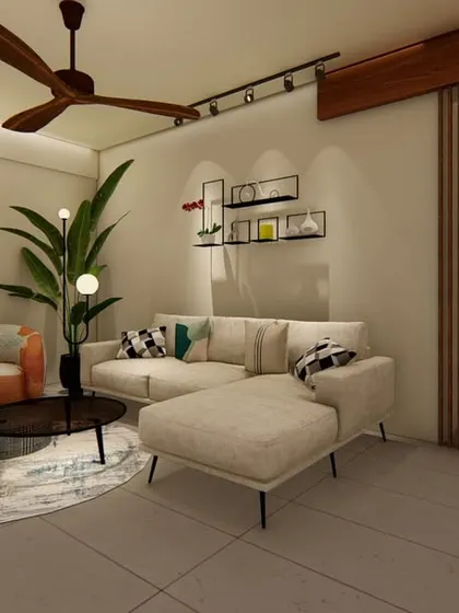 An example of our minimalist living room design, featuring a neutral-toned L-shaped sofa, a simple coffee table, and an accent armchair. The space is defined by clean lines, exposed brick, and a slatted wood partition.