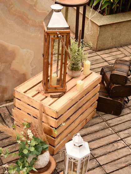 More details from the boho setup, including wooden trunks and lanterns that add to the rustic, traveled, and collected feel of the decor.
