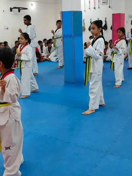 Students practicing their kicks during a belt exam.
