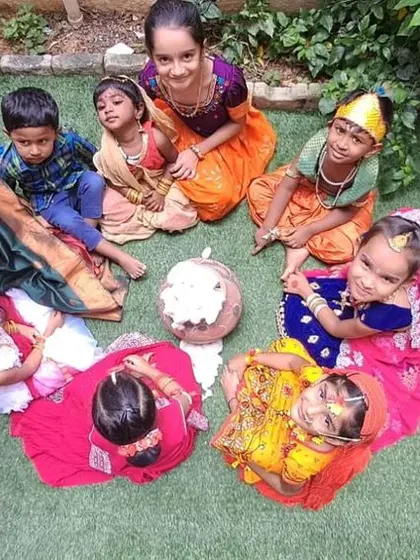 An aerial view of our little Asters dressed as Krishna and Radha, gathered around the 'matka'. Group activities like this make festival celebrations a shared, joyful experience.