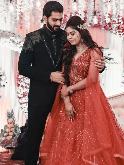 The groom, in his custom Madaan Tailors suit, shares a tender moment with his bride. Our outfits are designed to make your special day even more memorable.