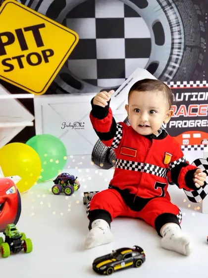 Ready, set, go! For the little one who's always on the move, my race car theme is a total winner. The checkered flags, pit stop signs, and cool cars make for such an energetic and fun first birthday photoshoot.