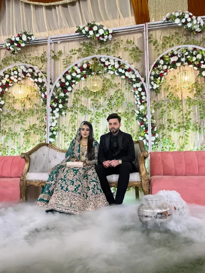 The couple poses on stage after their grand entry. The stage is filled with smoke, creating a 'dancing on the clouds' effect.