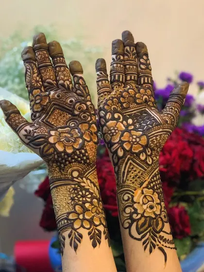 This intricate design covers the entire hand with a mix of floral, paisley, and geometric elements. It's a statement piece for any special occasion.
