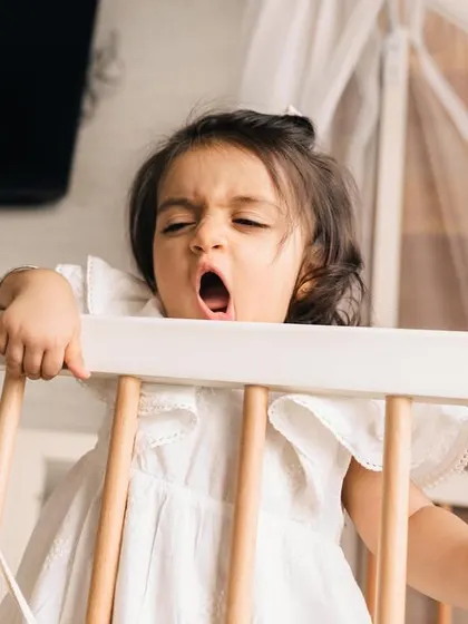 A real moment from a one-year-old's day, a big yawn in her crib. I love capturing these authentic, unscripted parts of childhood during my in-home lifestyle sessions.