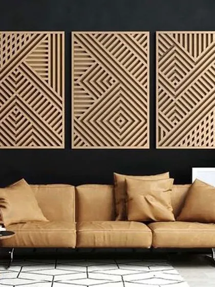 This living room showcases a bold design choice with geometric wood art panels against a dark wall. The contrast creates a dramatic focal point, complemented by the neutral tones of the furniture.
