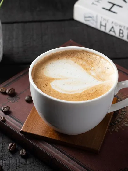 Another take on a classic coffee shot, this time with a darker, more intimate feel. The heart-shaped latte art is the central focus, adding a touch of warmth.