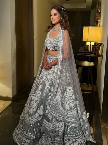 The bride's full lehenga, with her simple half-up hairstyle providing a touch of understated elegance.