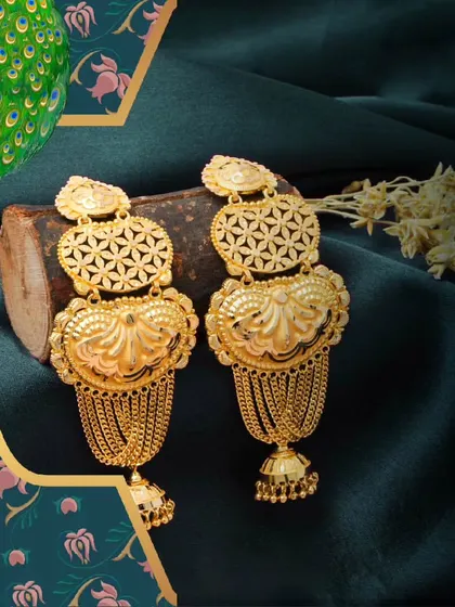 Earrings as unique as your personality. These large, ornate gold earrings feature a heart-shaped motif and cascading chains, designed to make a bold statement.