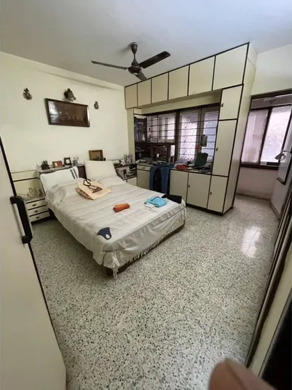 **BEFORE:** The master bedroom featured old, built-in wardrobes and a small window, making the space feel confined.