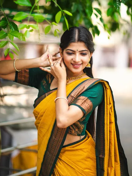 A modeling shoot for an apparel brand, where I could bring my dance expressions to the forefront. The yellow 'Manjal' saree and the natural setting created a vibrant, earthy feel.