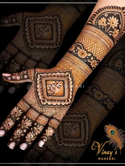 A personalized back-hand design with initials, surrounded by intricate floral and geometric patterns.