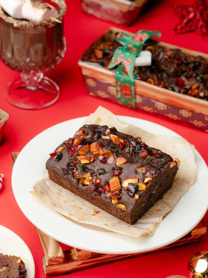 The quintessential Christmas dessert, a rich plum cake. We styled this shot with a cozy, festive theme to evoke the warmth and joy of the season.