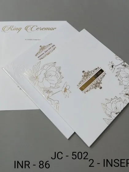 A beautiful white invitation with gold foil floral line art and a simple nameplate. The design is clean, modern, and effortlessly chic.