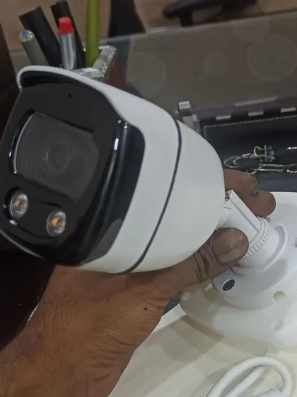 Holding a new bullet camera before installation. We only work with quality hardware to ensure your system is reliable.