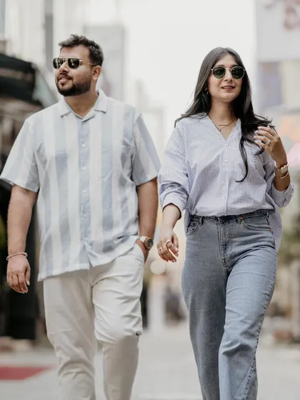 A candid shot of a couple walking, capturing their individual style and their connection as they move together. This is great for couples who want a natural, unposed feel to their photos.