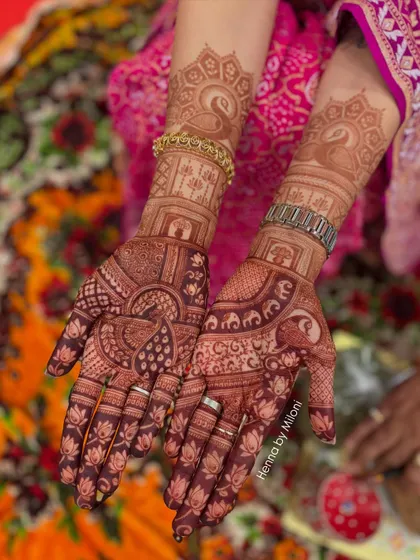 The rich, dark stain of this bridal mehendi after 24 hours. The design features peacocks, elephants, and jharokhas, all beautifully developed into a deep maroon color.