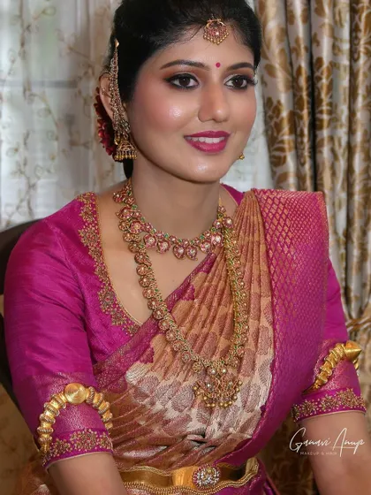 A full-look portrait of the bride's engagement attire. The makeup is soft and glamorous, with a focus on her eyes and a flawless skin finish.
