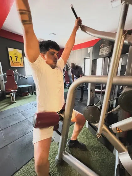 A client uses a lat pulldown machine, a great tool for building a wider, stronger back.