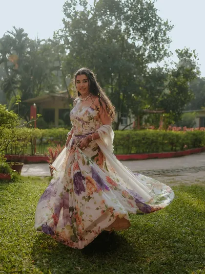 A beautiful shot of the bride twirling in her floral gown. The motion captures the flow of her dress and her joyful spirit.