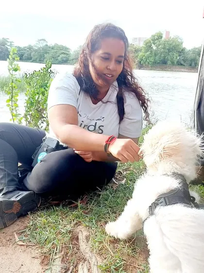 This is me with Ginger, a sweet Maltipoo who was once a very nervous pup. Building his trust with positive interactions and patience was key to his transformation.