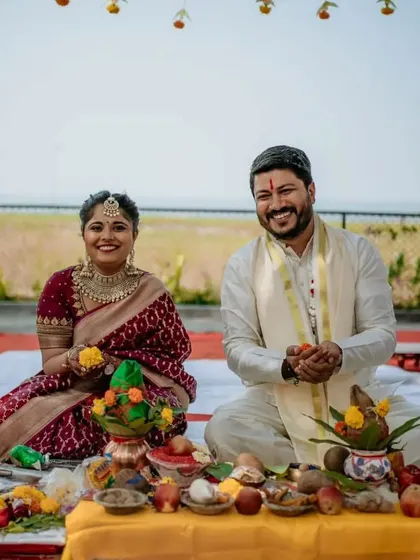 The couple seated for their wedding puja, smiling happily. A great shot capturing the rituals of a South Indian wedding.