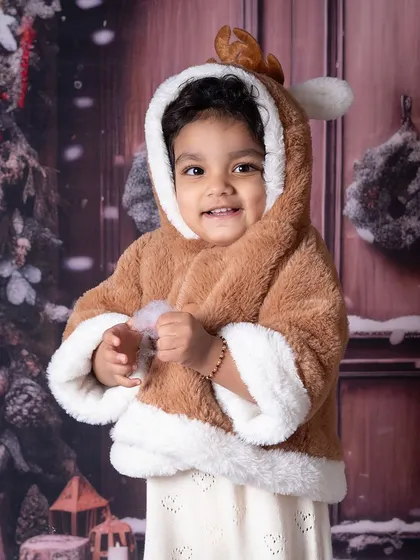 An adorable toddler in a reindeer poncho. I love finding unique and cute outfits for my holiday mini sessions.