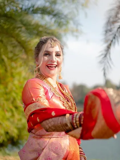 A happy portrait of a foreign bride enjoying her Indian wedding, her smile and energy lighting up the frame.
