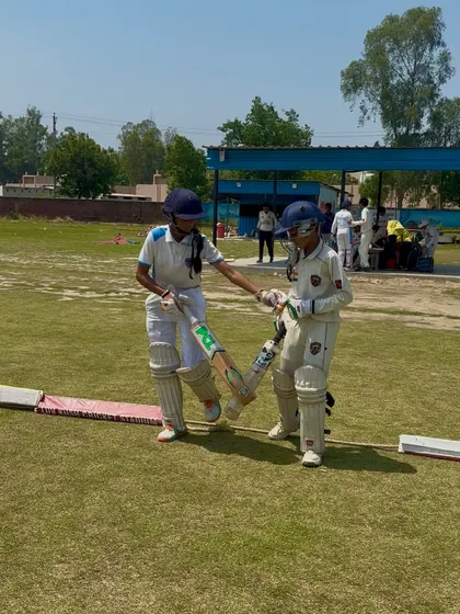 The opening partners share a word before starting the innings.