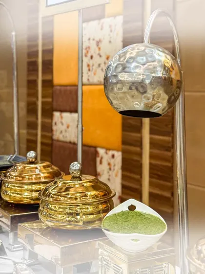 An elegant starter table setup featuring our signature serveware. The combination of golden bowls and modern lighting creates a luxurious and inviting display.